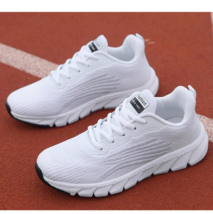 Women's black and white running shoes with cross strap detail and MD shock absorption sole