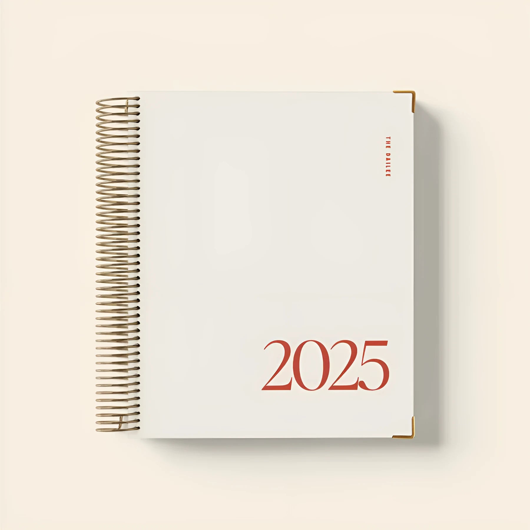 Cherry red daily schedule coil notebook open showing wire binding and printed schedule pages
