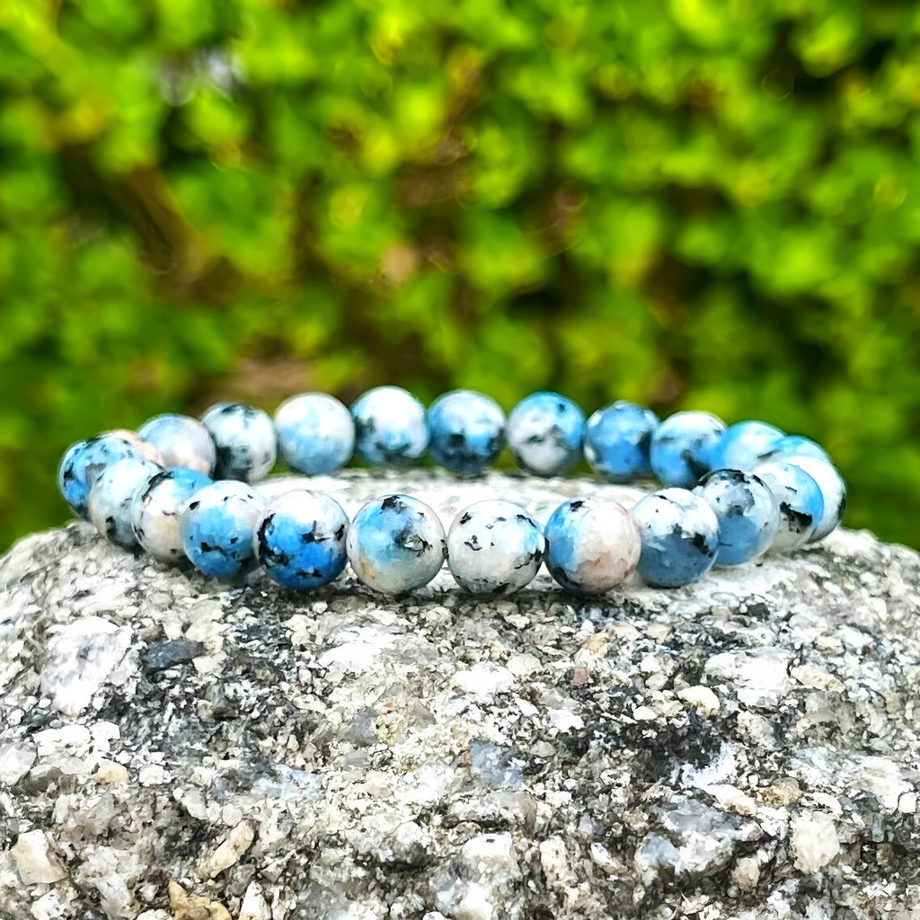 Handmade geometric bracelet made from blue K2 Azurite stone beads on a wrist.