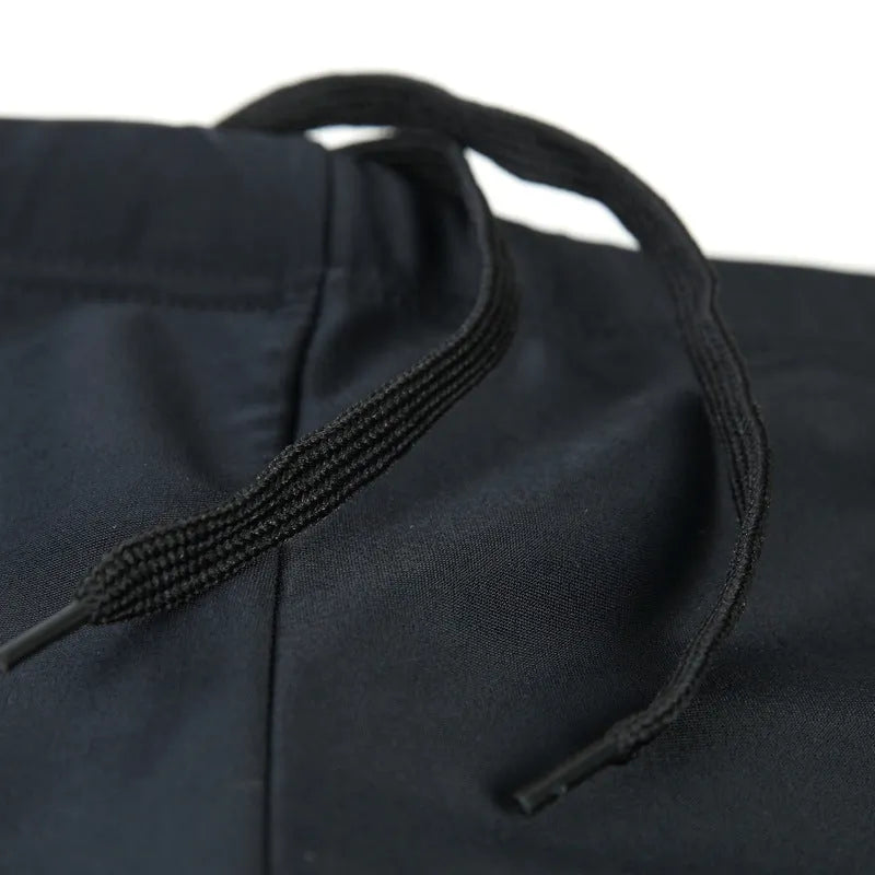 Men's plus size black swimming trunks with blue flame pattern and matching swimming cap.