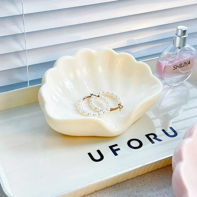 White or pink plastic shell-shaped soap dish for bathroom use