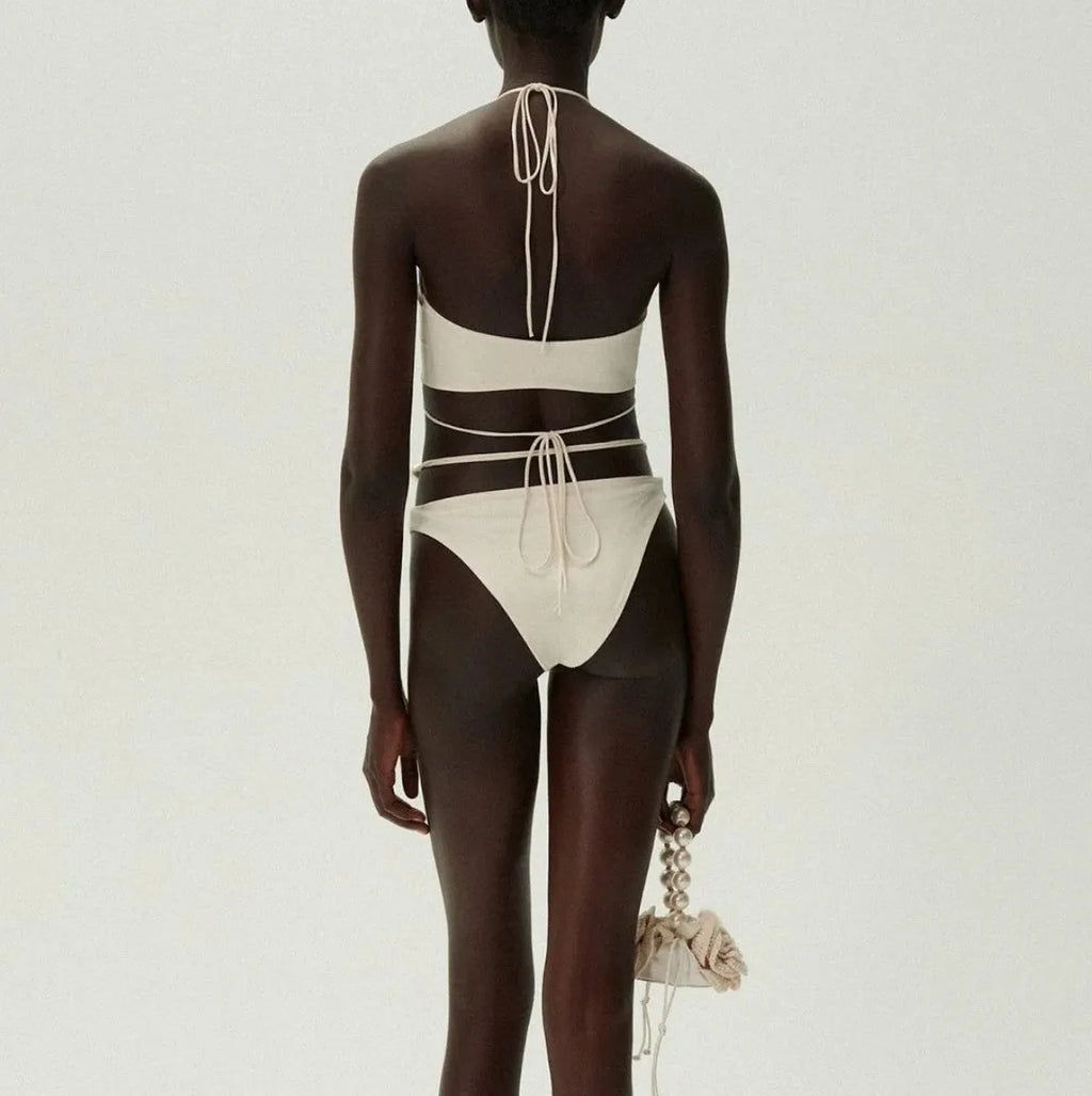 Women's black lace-up bikini swimsuit set with bra and shorts on white background