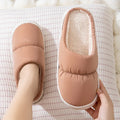 Down cotton house slippers with artificial leather upper, rubber sole, and plush lining in blue colour