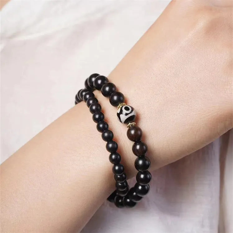 Ebony wood Tibetan prayer bead bracelet showing 8mm diameter and natural wood grain