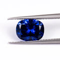 Royal blue gemstone in heart shape with modern cut on neutral background