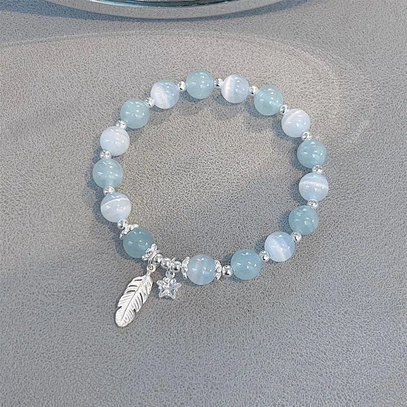 Glass crystal bracelet with coloured glaze in blue moonlight colour showing text modelling and eight-point star detail