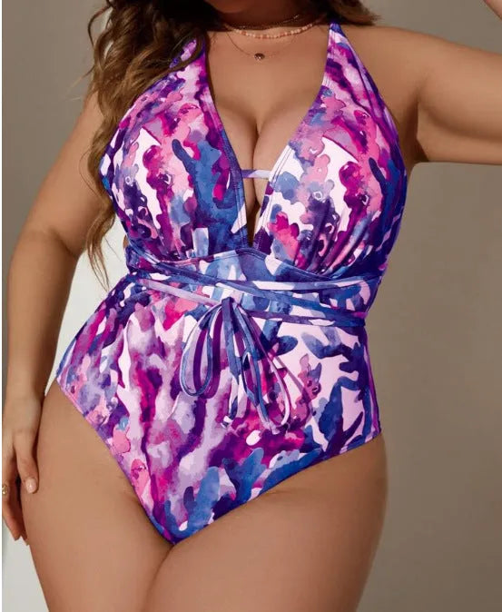 Purple women's one-piece halter swimsuit with bikini briefs on a mannequin.