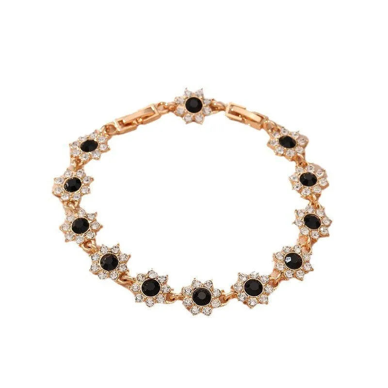 European style electroplated bracelet with flower-shaped coloured gemstones on a metallic chain.