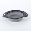 Black silicone pet bowl shown both folded flat and snapped open, next to a dog leash.
