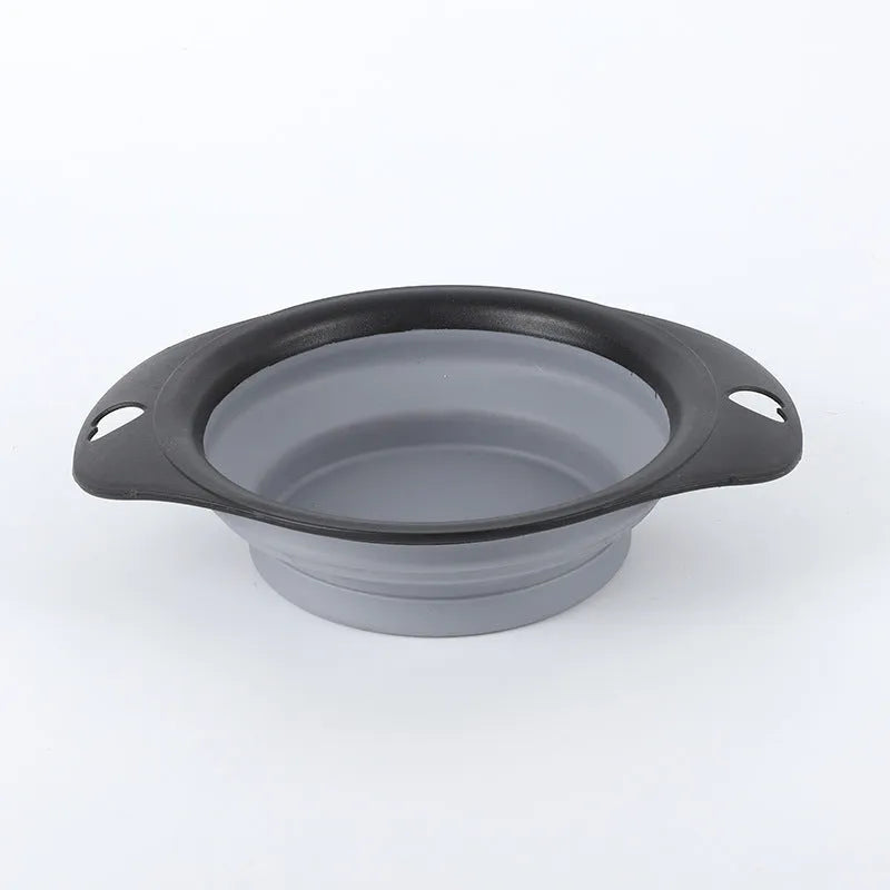 Black silicone pet bowl shown both folded flat and snapped open, next to a dog leash.