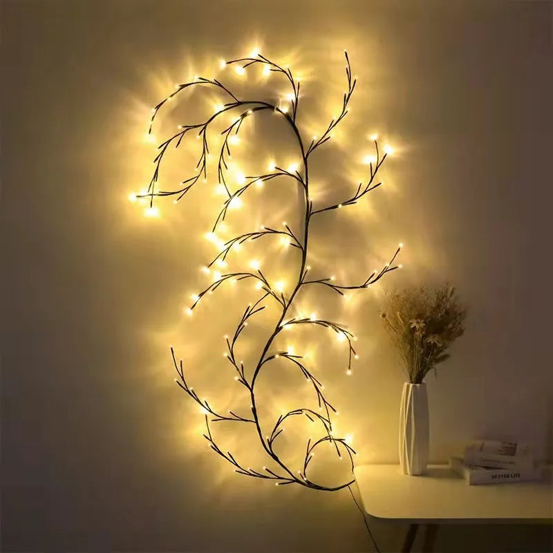 Flexible LED willow vine light garland with warm white bulbs shaped on a wall.