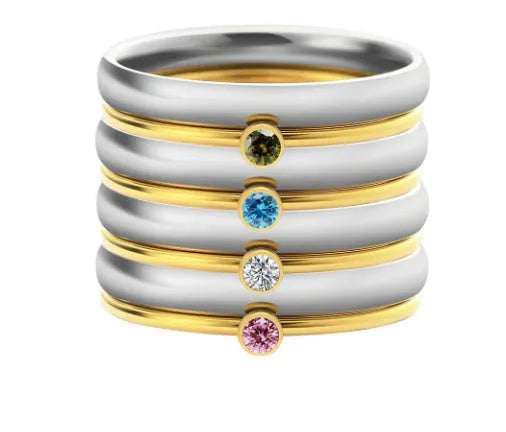 Geometric titanium steel ring with engraved detail and December birthstone colours on a white background
