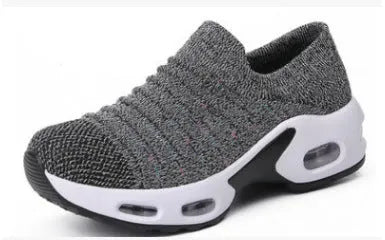 Stretch knitted mesh sock shoe for women in light grey colour with round toe and low heel.