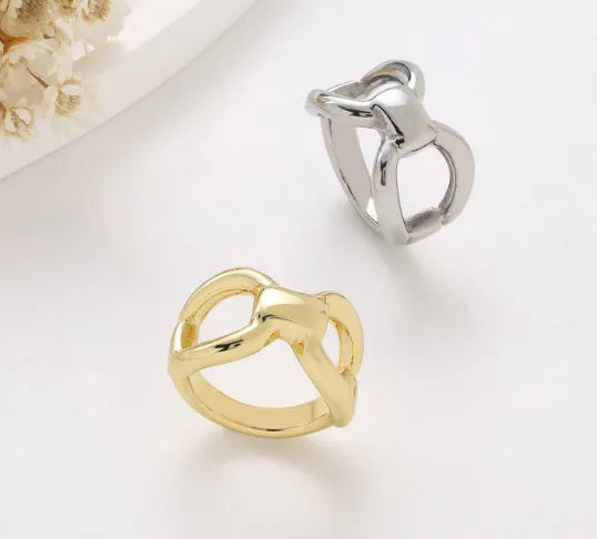 Women's butterfly bow hollow ring in titanium steel with geometric cut-outs, gold and steel colour options