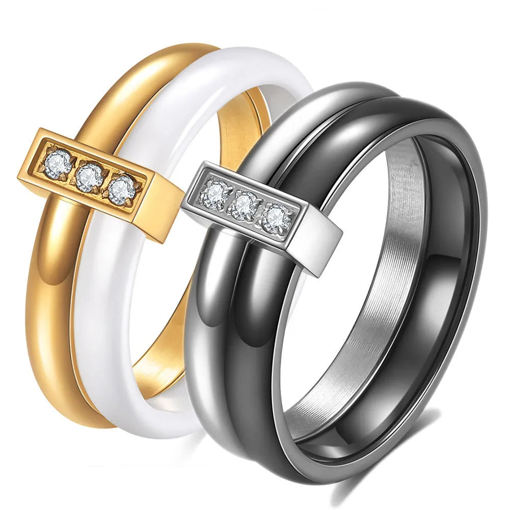 Glossy ceramic women's ring with inlaid zirconium design in geometric shape, shown in gold white finish.