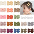 Assortment of pastel coloured baby hair clips and bows with fully lined, no-slip grips.
