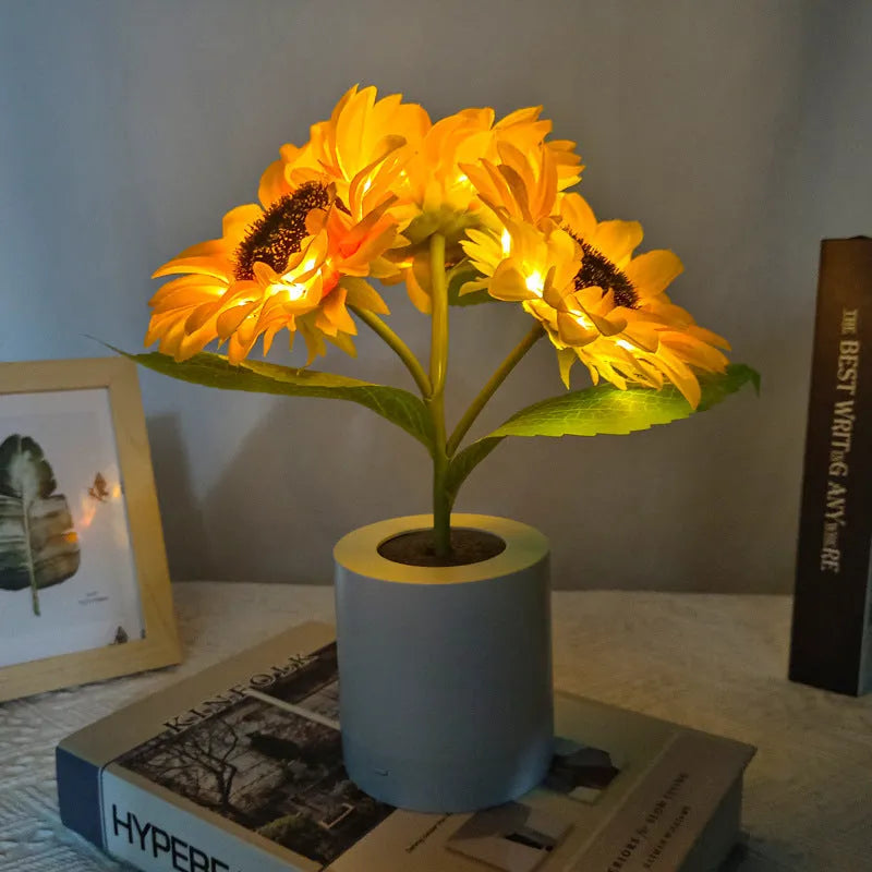 Sunflower LED night light with artificial flowers on wooden table