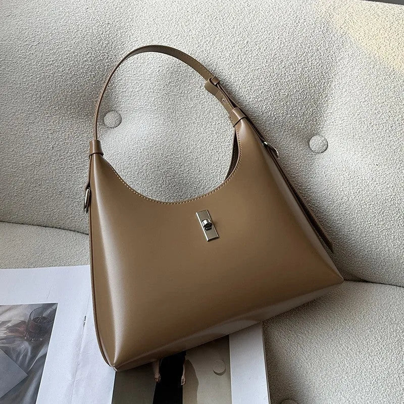 Genuine leather dumpling-shaped crossbody shoulder bag in apricot colour with street-trend details.