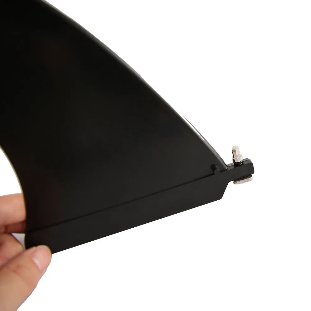 SUP paddle with removable fish fin component showing screw attachment point