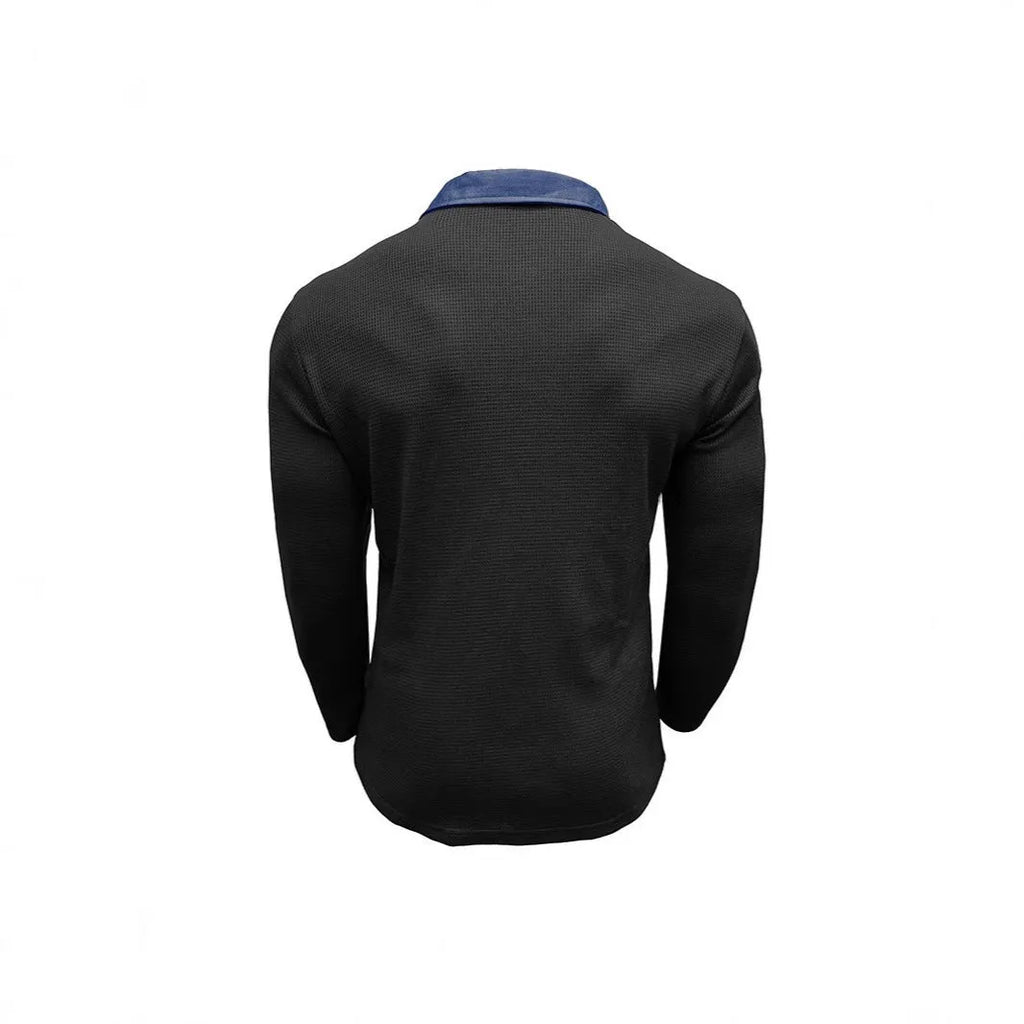Man wearing a loose-fit dark grey waffle-texture long-sleeved polo shirt with an asymmetric style detail.