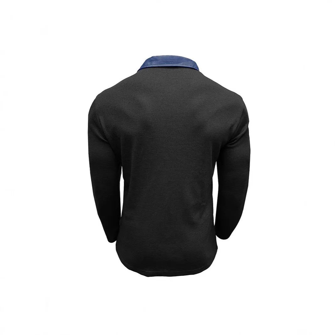 Man wearing a loose-fit dark grey waffle-texture long-sleeved polo shirt with an asymmetric style detail.