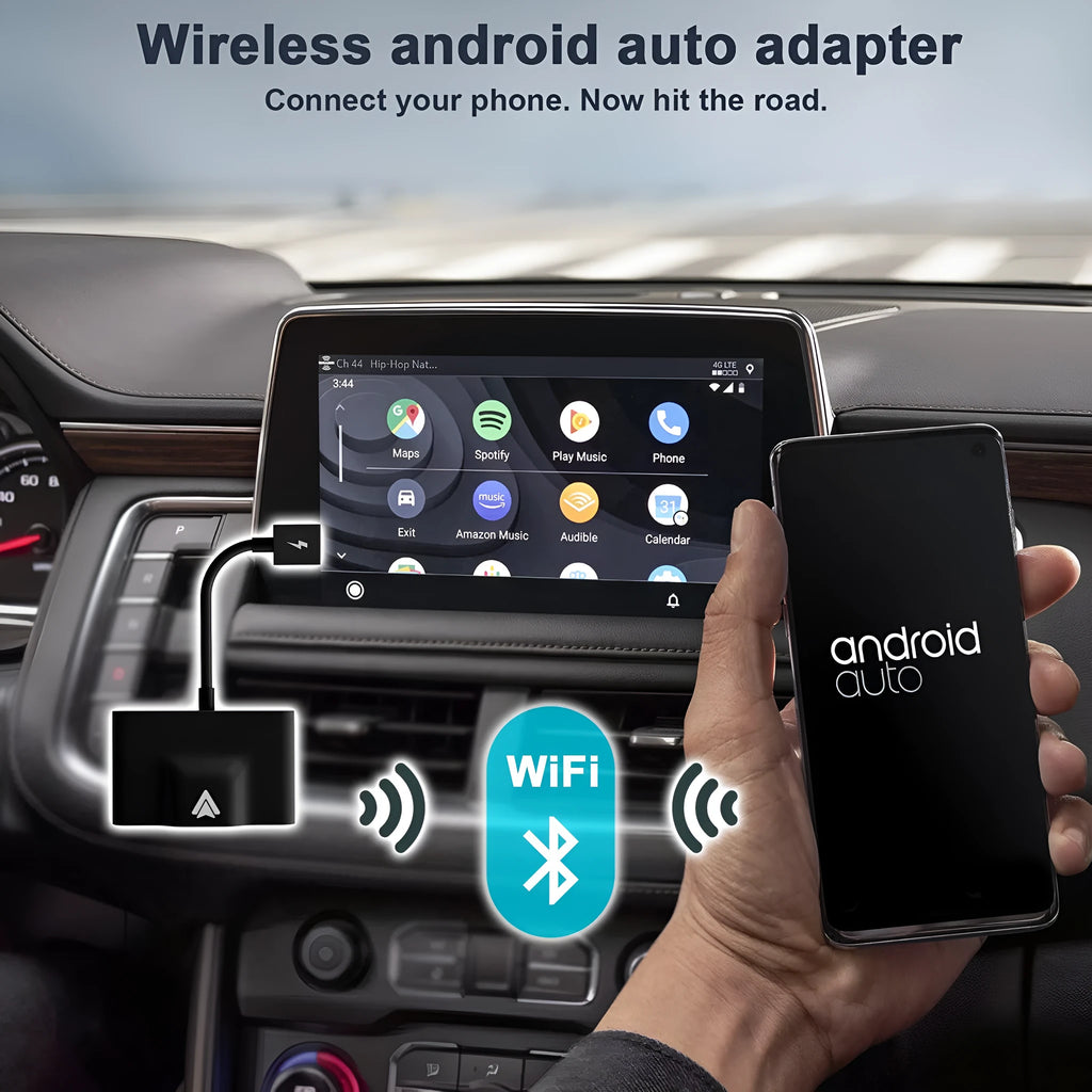 Black and white wireless Carplay adaptor for Android phones next to a car steering wheel