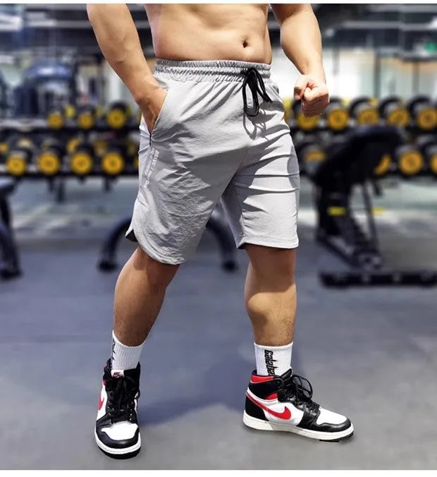 Men's black quick-drying sports running shorts with contrast side panels, shown in a size L.
