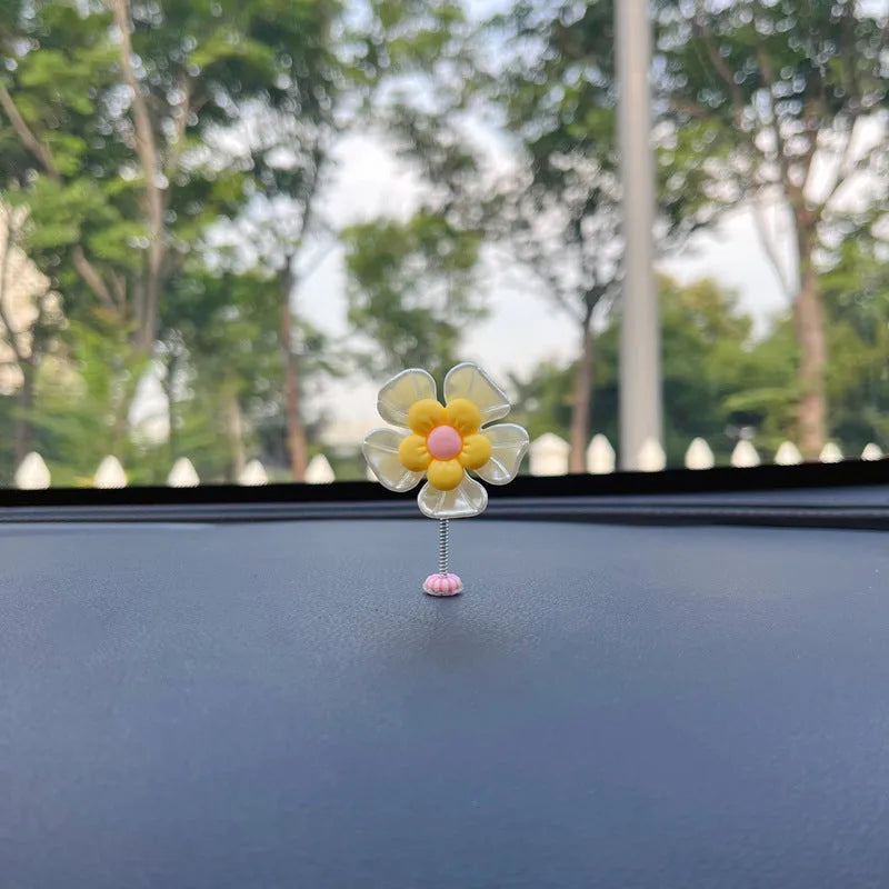 Small plastic colourful swing car decoration shown in multiple colour options.