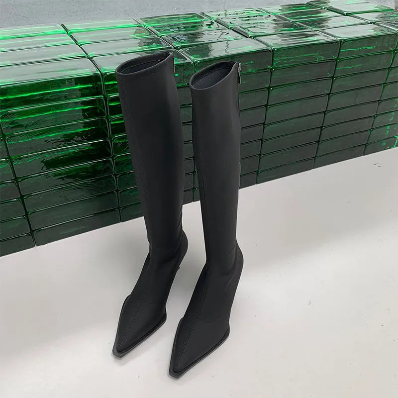 Black pointed toe women's ankle boots with a stiletto heel and a back zipper closure.