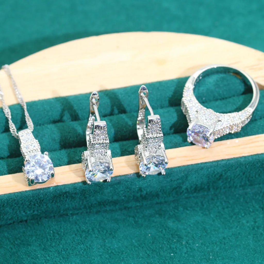 Bridal four-piece jewellery set showing necklace, earrings, ring and bracelet with water wave chain design