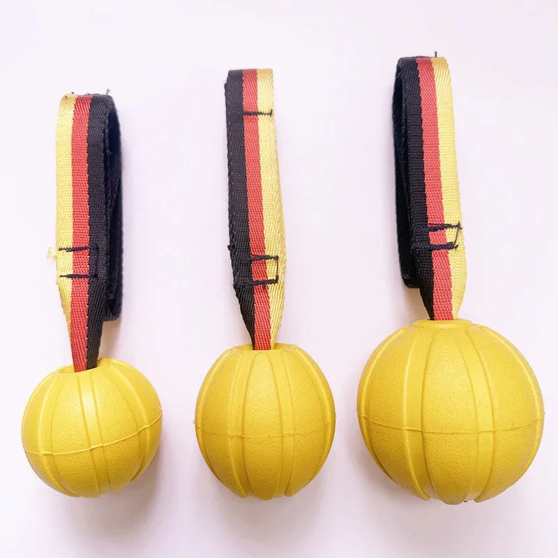 Yellow and camouflage coloured EVA floating dog tetherballs in different sizes on a blue background.