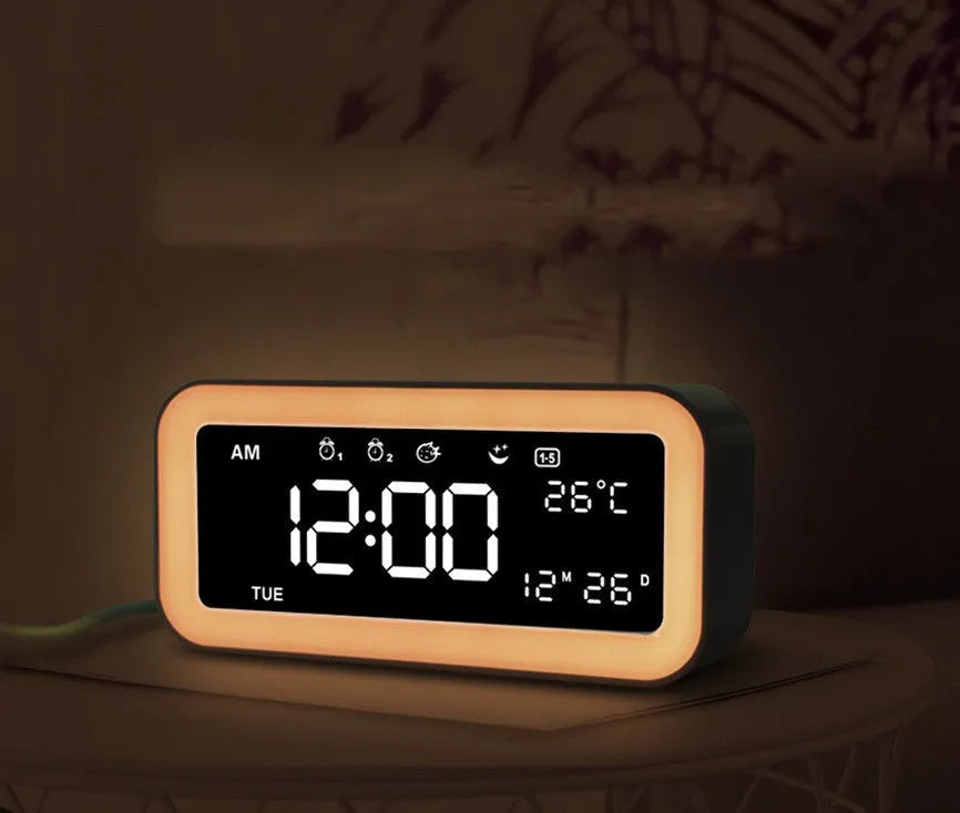Blue rectangular LED digital alarm clock with multicoloured ambient light display.