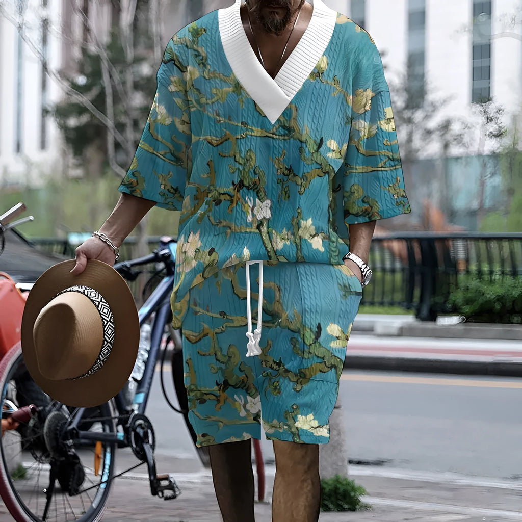 Peacock blue men's knitted casual suit with matching T-shirt top and shorts laid flat.