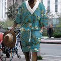 Peacock blue men's knitted casual suit with matching T-shirt top and shorts laid flat.