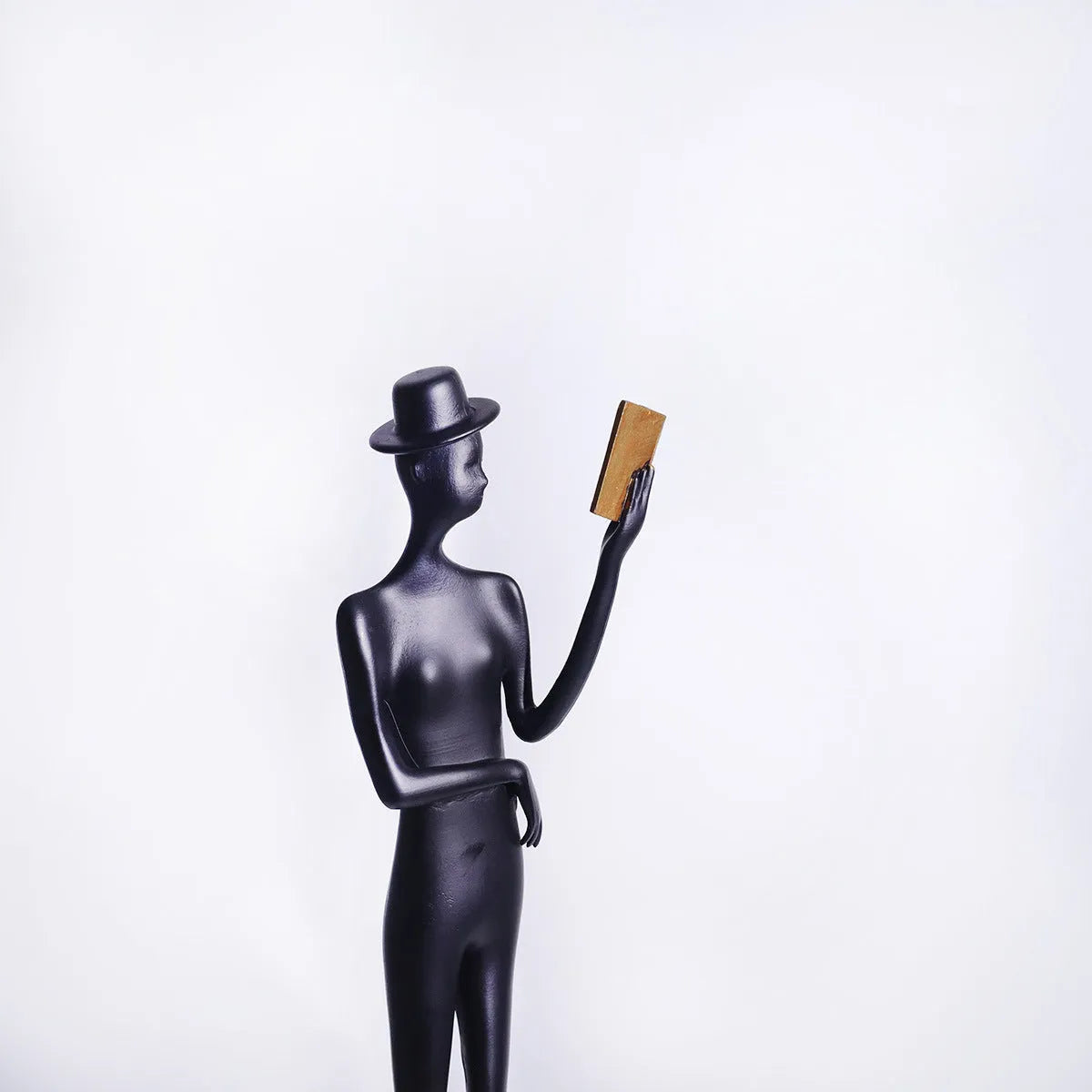 Black cast aluminium reading woman sculpture, 51cm tall modern desktop ornament.