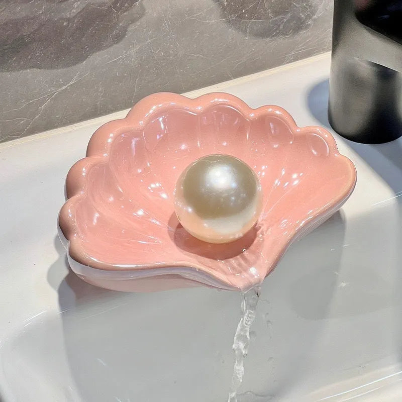 White or pink plastic shell-shaped soap dish for bathroom use