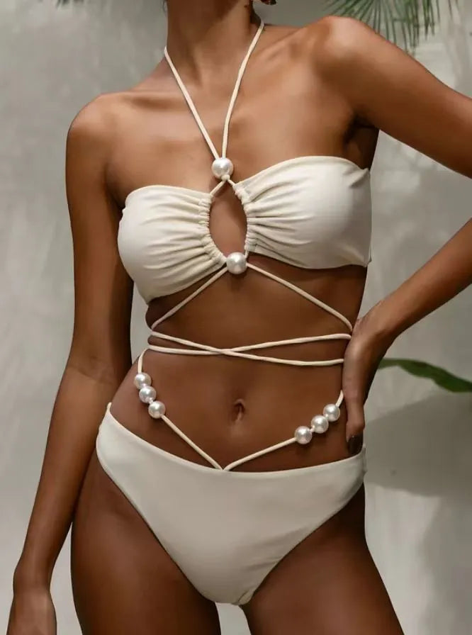 Women's black lace-up bikini swimsuit set with bra and shorts on white background