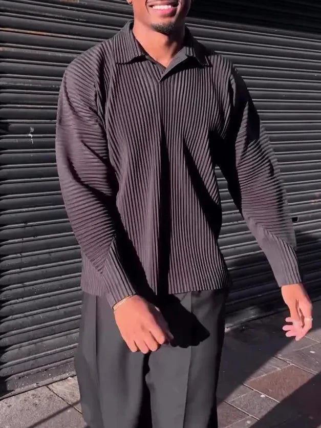 Men's black long-sleeved casual top with a pleated detail on the front.