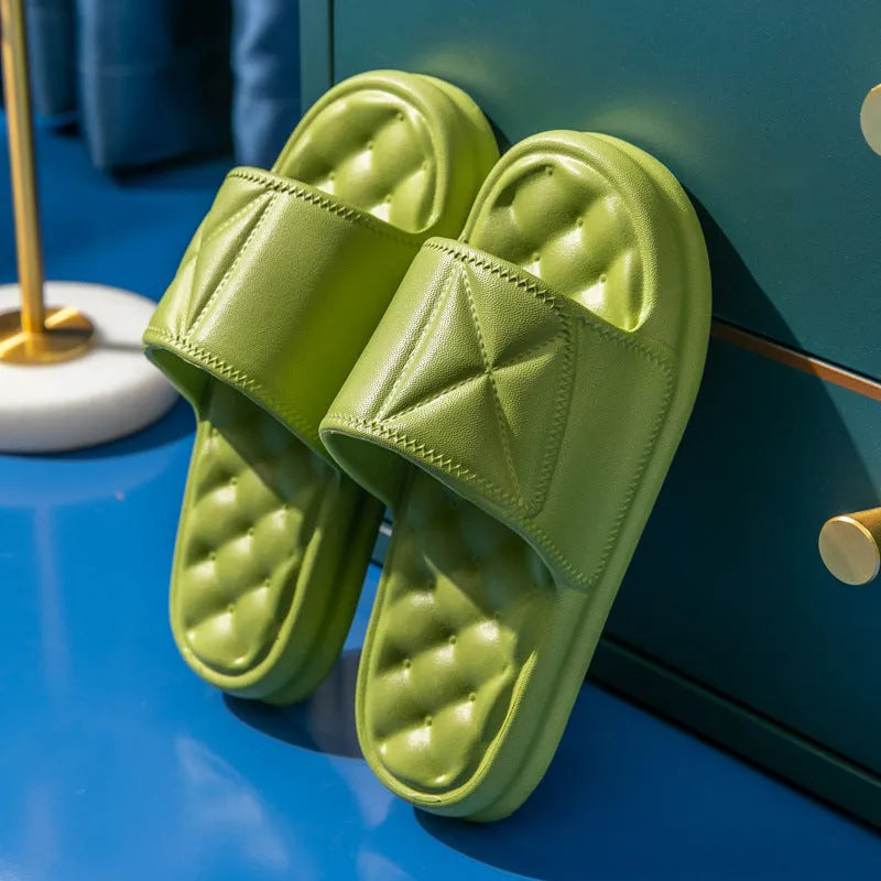 A pair of soft EVA couples bath sandals with a thicker sole, shown in a choice of colours on a bathroom floor.
