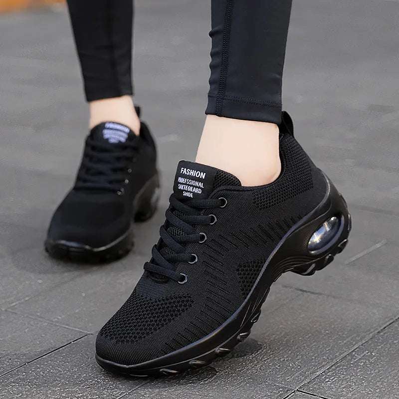 Red and black women's low-top lace-up mesh sneakers with a round toe and mid heel on a PU sole.