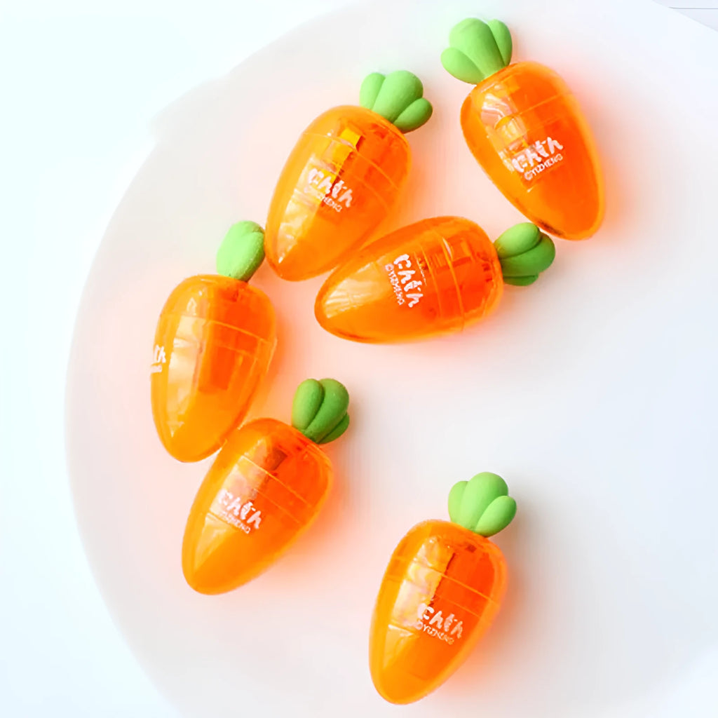 Orange carrot-shaped plastic pencil sharpener with cartoon design showing 7cm handle length