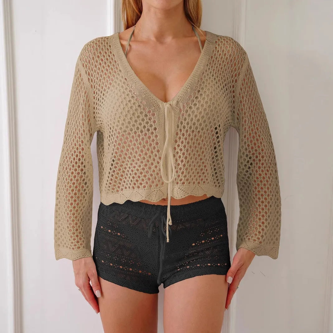 Short apricot coloured women's cardigan blouse with hollow weave texture and flared bell sleeves.