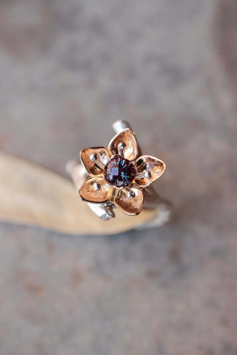 Silver two-tone floral geometric alloy women's ring shown on a white background.