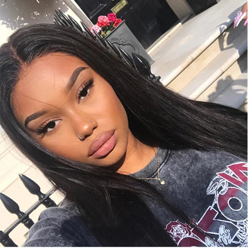 Long straight black synthetic wig with centre-parted bangs on a wig stand