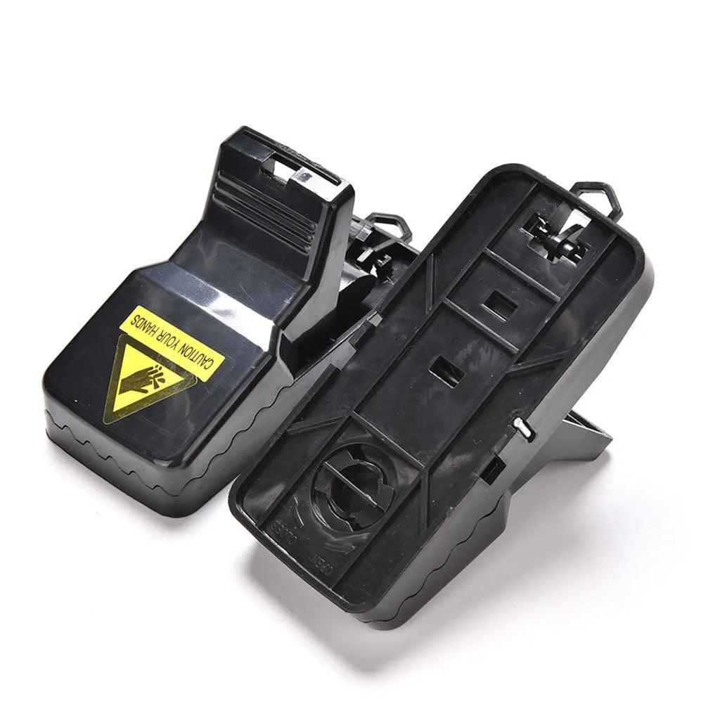 Set of six black plastic snapping mousetraps showing size and smooth surface