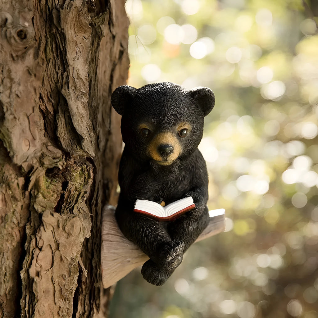Black bear solar light ornament in synthetic resin placed in garden with solar panel on top