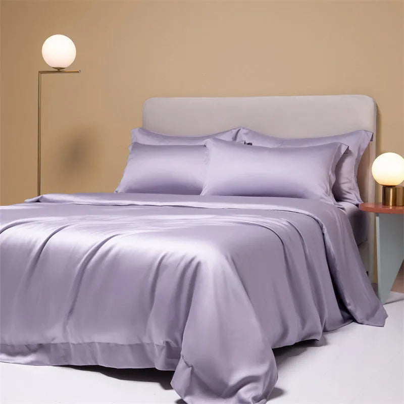 200 thread count Lenzing Tencel quilt cover and sheet set in Aurora Blue, laid on a bed.