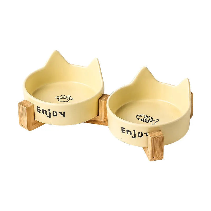 Porcelain cat bowl with wooden anti-tumble frame in pink with cat paw design