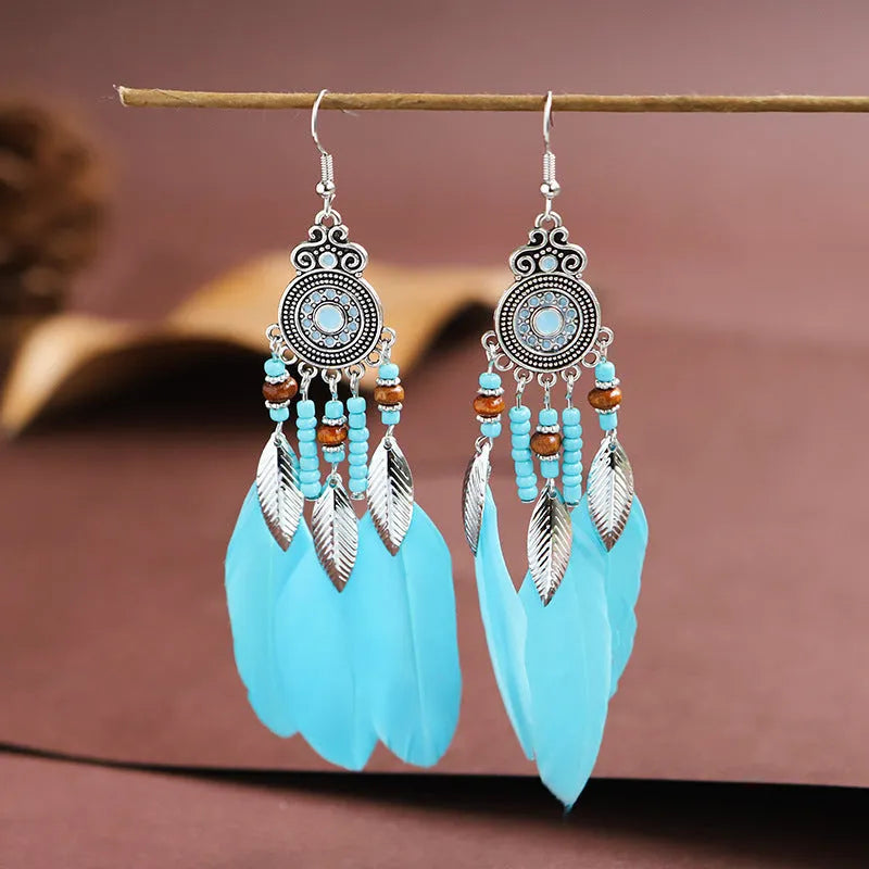 Round drop feather earrings with alloy construction and patterned design in various colour options
