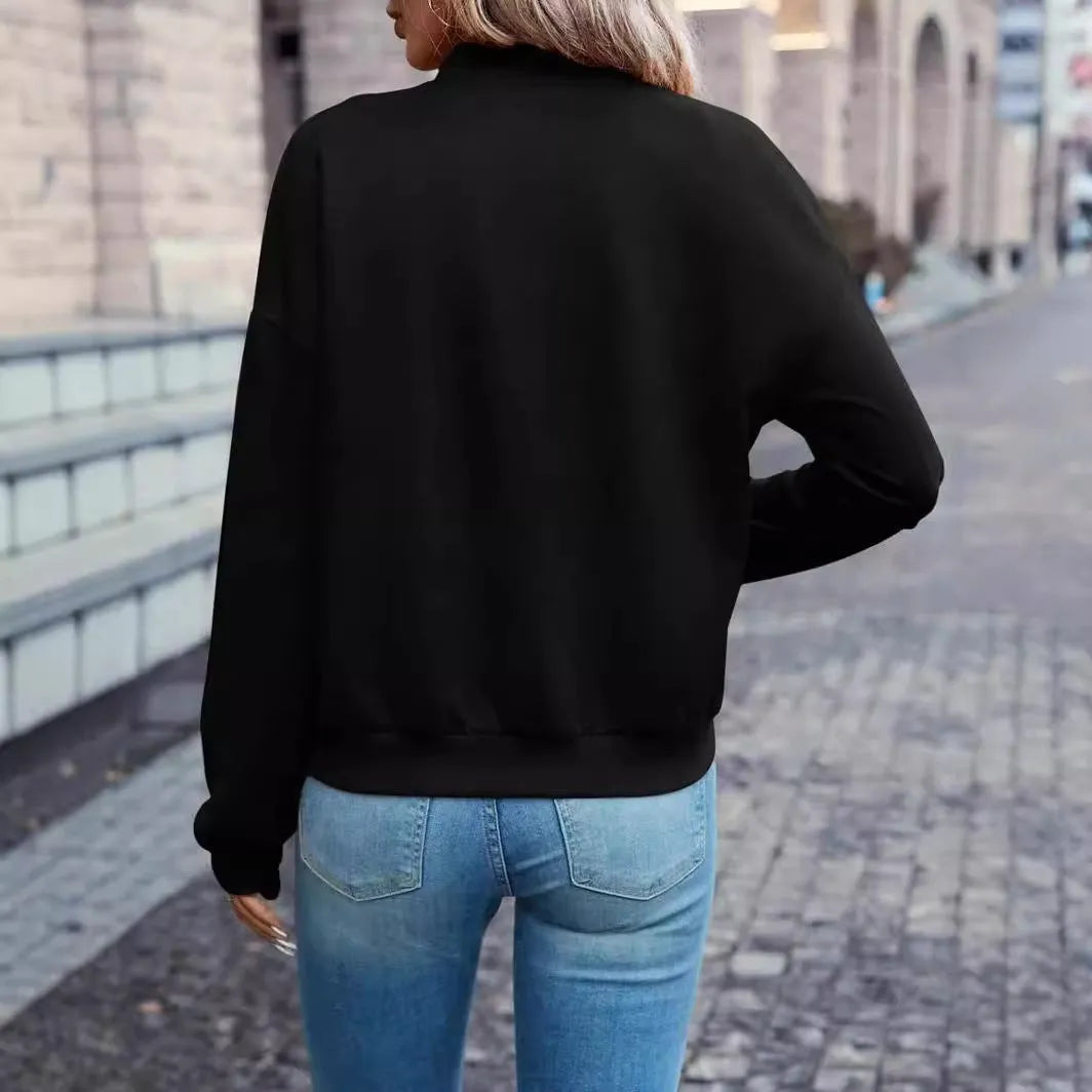 Women's solid black casual zip jacket with long sleeves, shown on a model.
